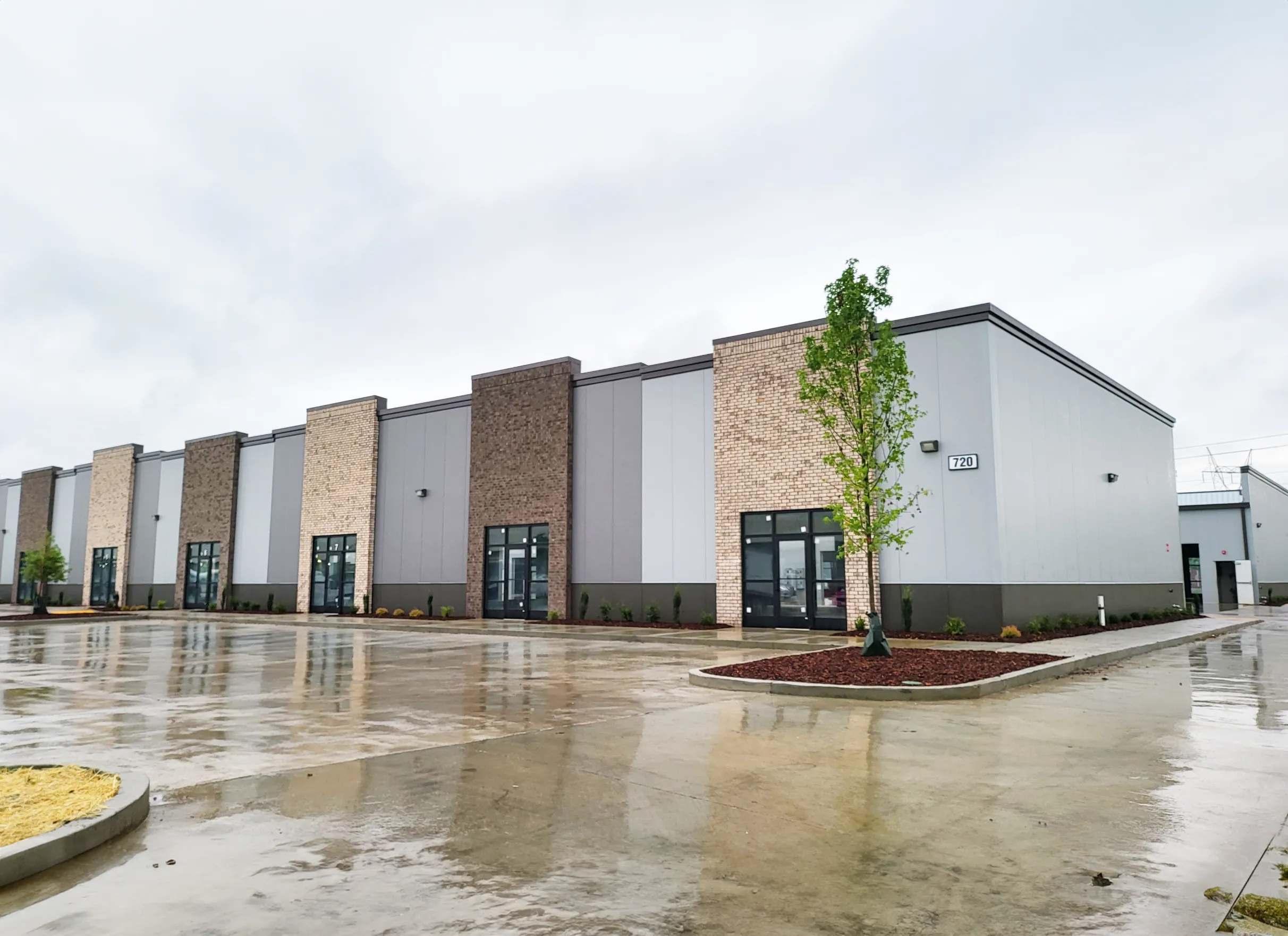Red building with canopy over picnic tables